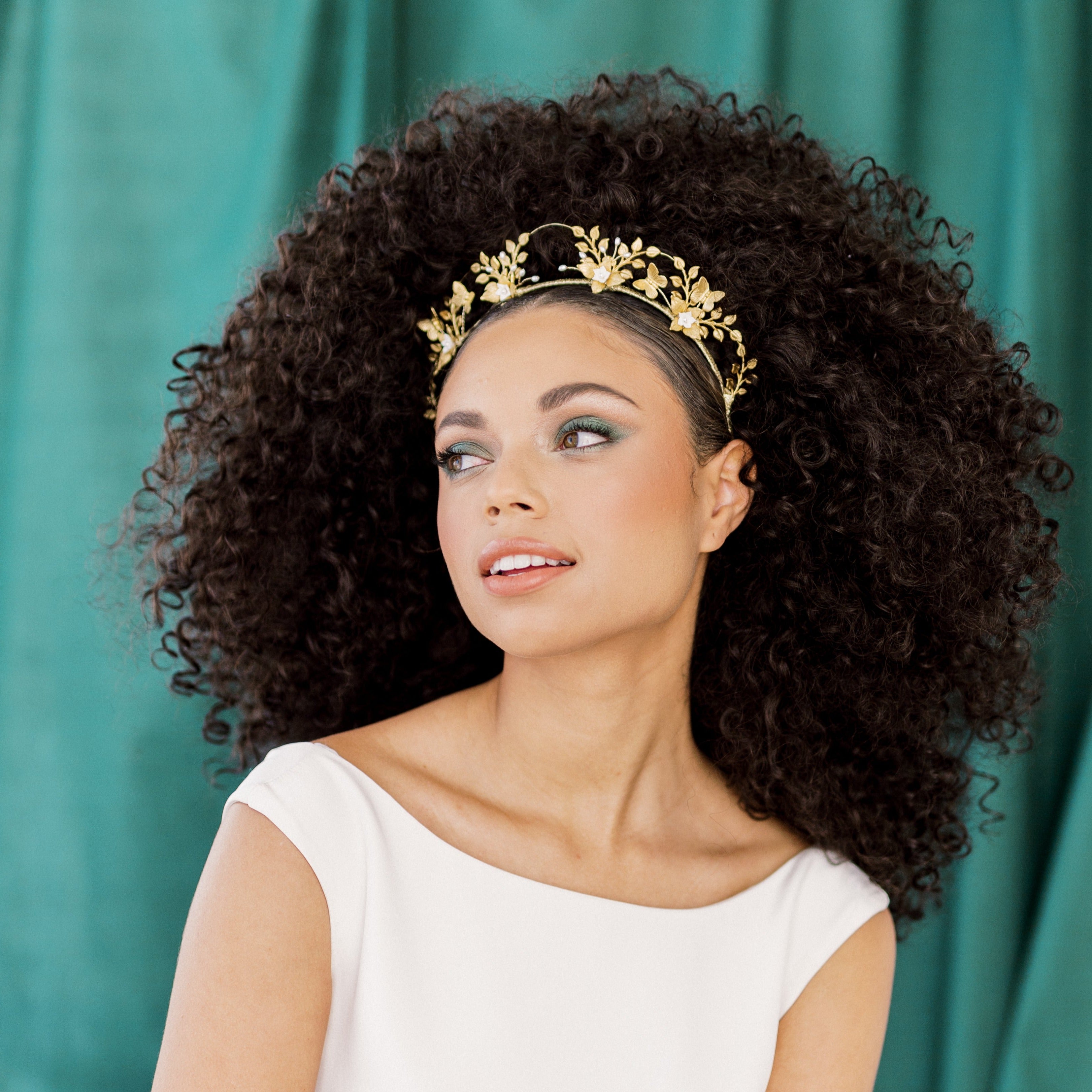 Tall scalloped golden brass bridal crown with butteflies, sprigs of ivory or white rice pearls and blooming clay flowers. Handmade in Toronto Canada by Blair Nadeau Bridal Adornments